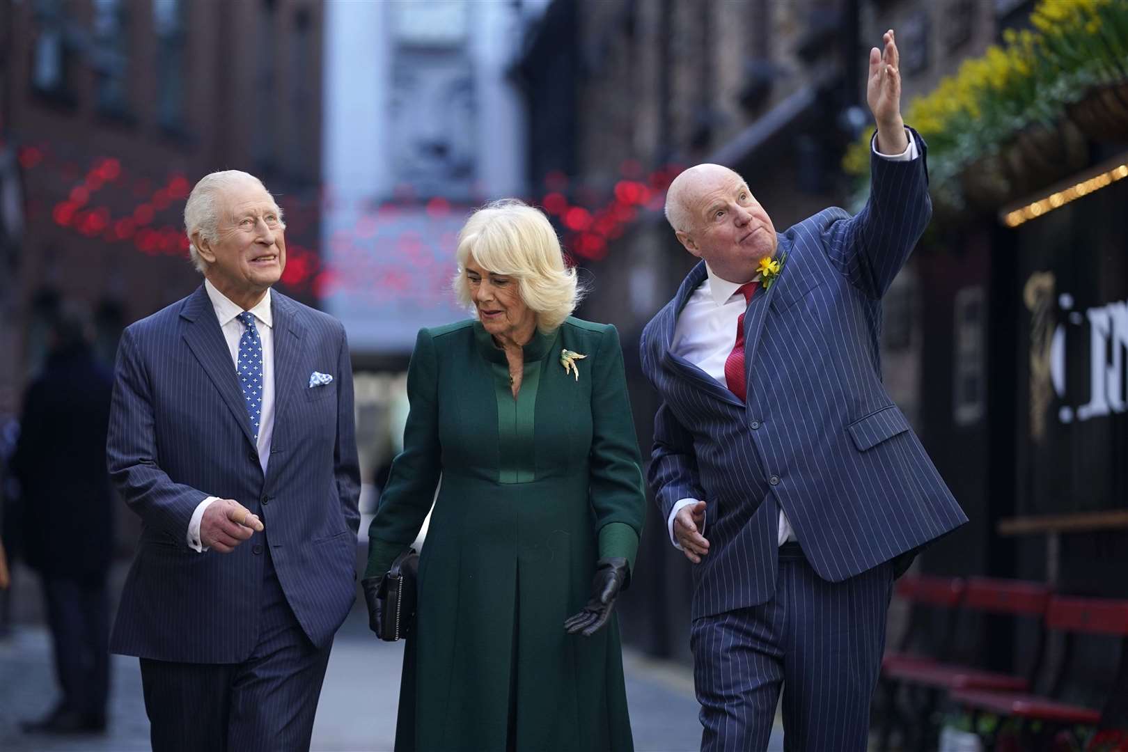 The King and Queen talk to local businessman Willie Jack, right, during their visit (Niall Carson/PA)